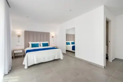a bedroom with two beds with blue pillows at Vila Luna B&B in Lagos