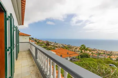 a balcony with a view of the ocean at Garden House in Funchal