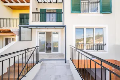 a home with a staircase leading to the front door at Villa Ana D'Arfet in Água de Pena