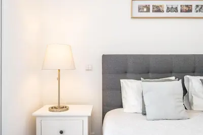 a bedroom with a bed with a lamp on a night stand at Villa Ana D'Arfet in Água de Pena