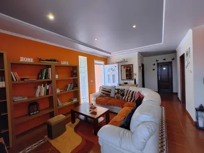 a living room with a couch and a coffee table at Casa Rosa - Vereda da Ilha in Santana
