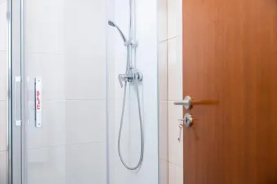 a shower in a bathroom with a glass door at Apartamentos Progresso 1º Esq in Funchal