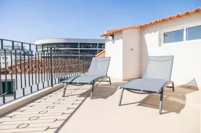 two chairs on the balcony of a building at Apartamentos Progresso 1º Esq in Funchal