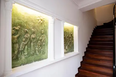 a painting on the wall next to a staircase in a house at Apartamentos Progresso 1º Esq in Funchal