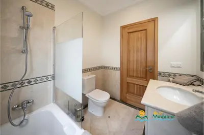 a bathroom with a toilet and a sink and a shower at OurMadeira - Palheiro Ocean in Funchal