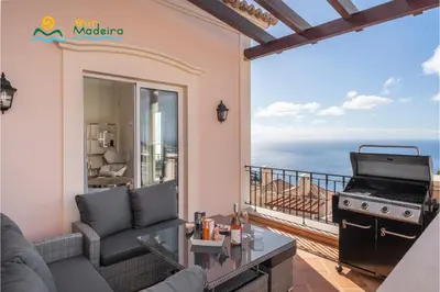 a living room with a view of the ocean at OurMadeira - Palheiro Ocean in Funchal