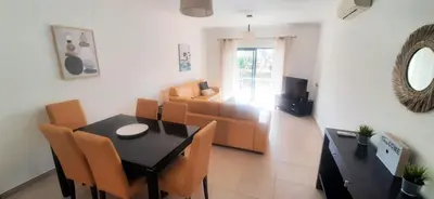 a living room with a table and chairs and a couch at Apartamento Buganvilia in Lagos