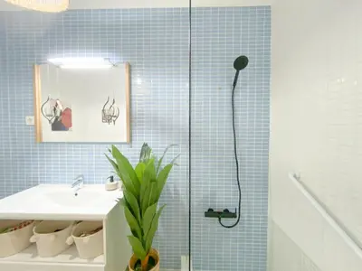 a bathroom with a sink and a shower with blue tiles at Cozy Retreat for Couples in Burgau #1937 in Burgau