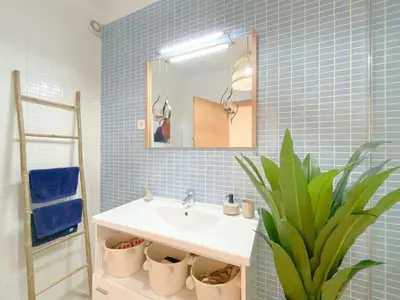 a bathroom with a sink and a mirror and a plant at Cozy Retreat for Couples in Burgau #1937 in Burgau