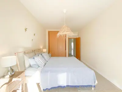 a white bedroom with a bed and a couch at Cozy Retreat for Couples in Burgau #1937 in Burgau
