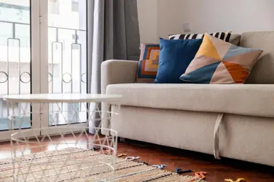 a living room with a couch and a table at Apartamentos Progresso 1º Dto in Funchal