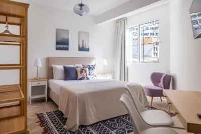 a bedroom with a bed and a desk and a chair at Apartamentos Progresso 2º Esq in Funchal