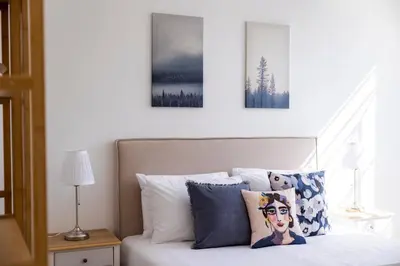 a bedroom with a bed with two pictures on the wall at Apartamentos Progresso 2º Esq in Funchal