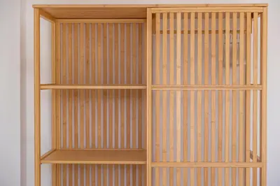 a wooden book shelf against a white wall at Apartamentos Progresso 2º Esq in Funchal