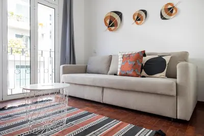 a living room with a couch and a table at Apartamentos Progresso 2º Dto in Funchal