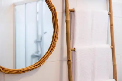 a bathroom with a mirror and a towel rack at Apartamentos Progresso 3º Esq in Funchal
