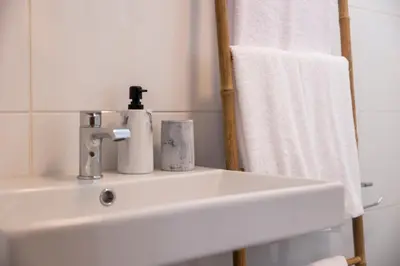 a bathroom sink with a soap dispenser on it at Apartamentos Progresso 3º Esq in Funchal