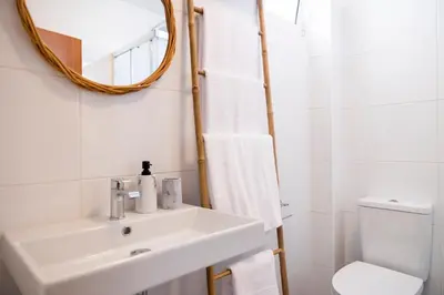 a bathroom with a sink and a mirror and a toilet at Apartamentos Progresso 3º Esq in Funchal