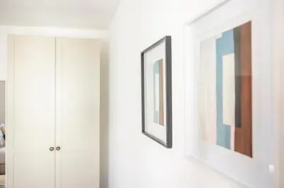 a hallway with two framed pictures on a wall at Apartamentos Progresso 3º Dto in Funchal
