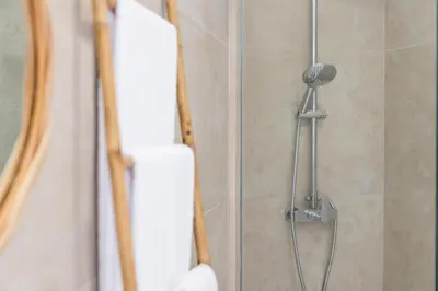 a shower with a shower head in a bathroom at Apartamentos Progresso 3º Dto in Funchal