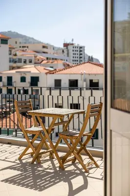 a wooden table and two chairs on a balcony at Apartamentos Progresso 3º Dto in Funchal