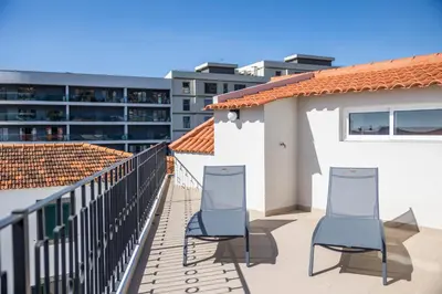 two chairs on the balcony of a building at Apartamentos Progresso 3º Dto in Funchal