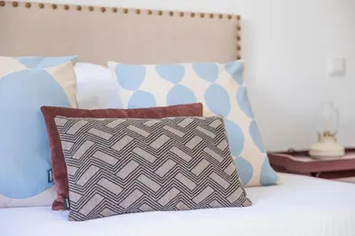 a bed with a pillow and pillows on it at Apartamentos Progresso 3º Dto in Funchal