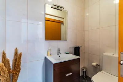 a bathroom with a sink and a mirror at Villa Alex,pool and ocean view in Calheta