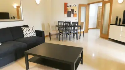 a living room with a couch and a table at Apartamento Íris in Lagos