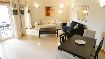 a living room with a couch and a table at Apartamento Íris in Lagos
