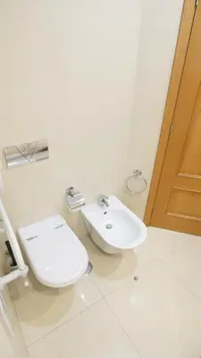 a bathroom with a toilet and a sink at Apartamento Íris in Lagos