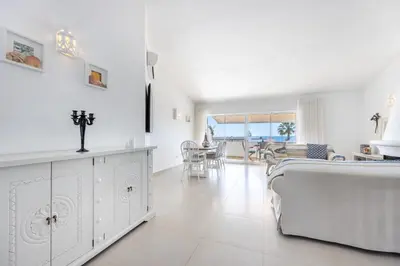 a white living room with a bed and a dining room at CoolHouses Algarve Luz, 3 Bed townhouse, lovely sea views, village centre, Casa Limoeiro 54LBC in Luz