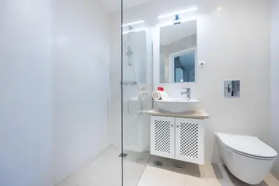 a white bathroom with a toilet and a sink at CoolHouses Algarve Luz, 3 Bed townhouse, lovely sea views, village centre, Casa Limoeiro 54LBC in Luz
