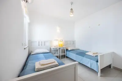 two beds in a white room with a desk and a bed at CoolHouses Algarve Luz, 3 Bed townhouse, lovely sea views, village centre, Casa Limoeiro 54LBC in Luz