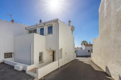 a white house with the sun in the sky at CoolHouses Algarve Luz, 3 Bed townhouse, lovely sea views, village centre, Casa Limoeiro 54LBC in Luz