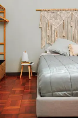 a bedroom with a bed and a table with a lamp at Quintinha Tropical - Panoramic Gateway to Madeira in Funchal