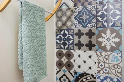 a bathroom with blue and white tiles on the wall at Quintinha Tropical - Panoramic Gateway to Madeira in Funchal