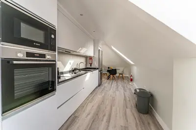 a kitchen with a sink and a stove at Penthouse Formosa Sunset and Beach in Funchal