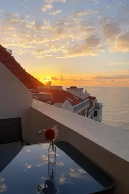 a view of the sunset from the balcony of a building at Penthouse Formosa Sunset and Beach in Funchal