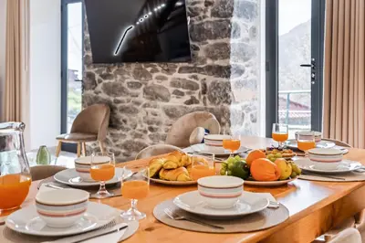 a table with plates of food and glasses of orange juice at AGUIAR´S VILLAGE in Ribeira Brava