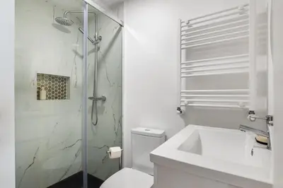 a bathroom with a shower and a toilet and a sink at AGUIAR´S VILLAGE in Ribeira Brava