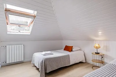 a white room with a bed and a window at AGUIAR´S VILLAGE in Ribeira Brava