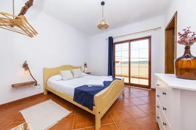 a bedroom with a bed and a large window at A56 - Westway Rossio Holiday Place in Luz