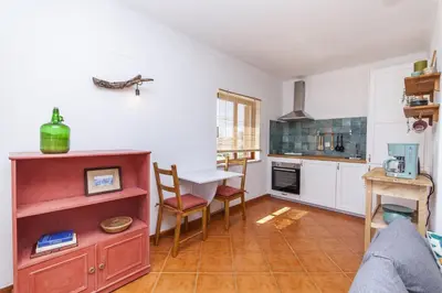 a kitchen with a table and chairs in a room at A56 - Westway Rossio Holiday Place in Luz