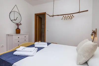 a bedroom with a white bed with towels on it at A56 - Westway Rossio Holiday Place in Luz