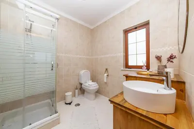 a bathroom with a sink and a toilet and a shower at A56 - Westway Rossio Holiday Place in Luz