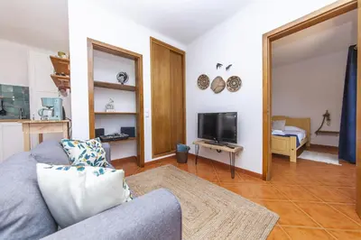 a living room with a couch and a tv at A56 - Westway Rossio Holiday Place in Luz