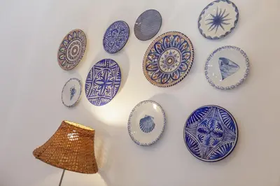 a wall with blue and white plates on a wall at B54 - Casa Azul in Burgau in Budens