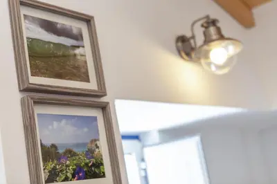 two framed pictures on a wall with a light at B54 - Casa Azul in Burgau in Budens