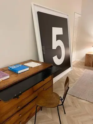 a desk with a chair and a sign with the number five at Downtown collection apartments in Funchal
